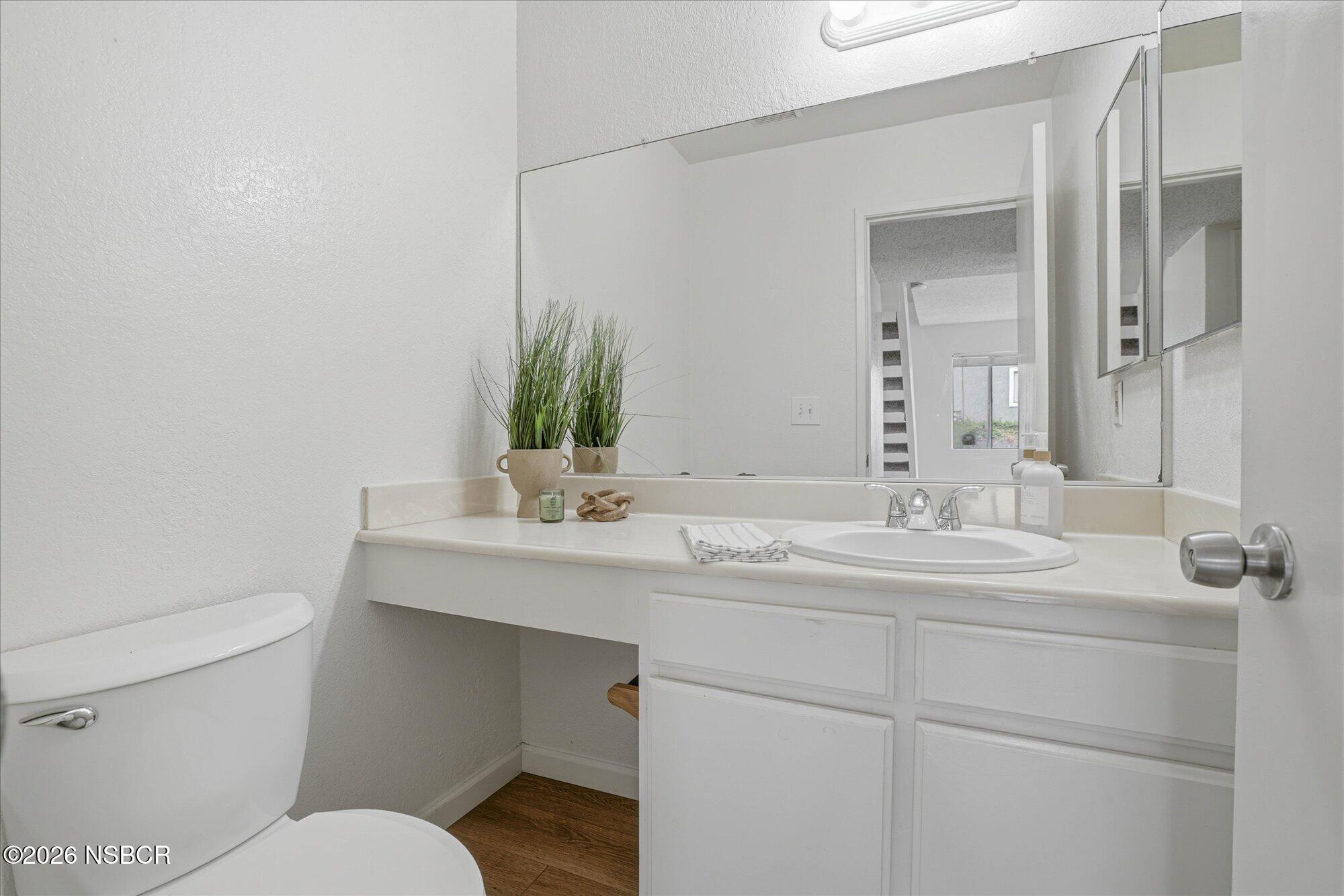1192 Sumner Place, Unit D Santa Maria, CA 93455 - Photo 9 of 18 a bathroom with a toilet sink and mirror