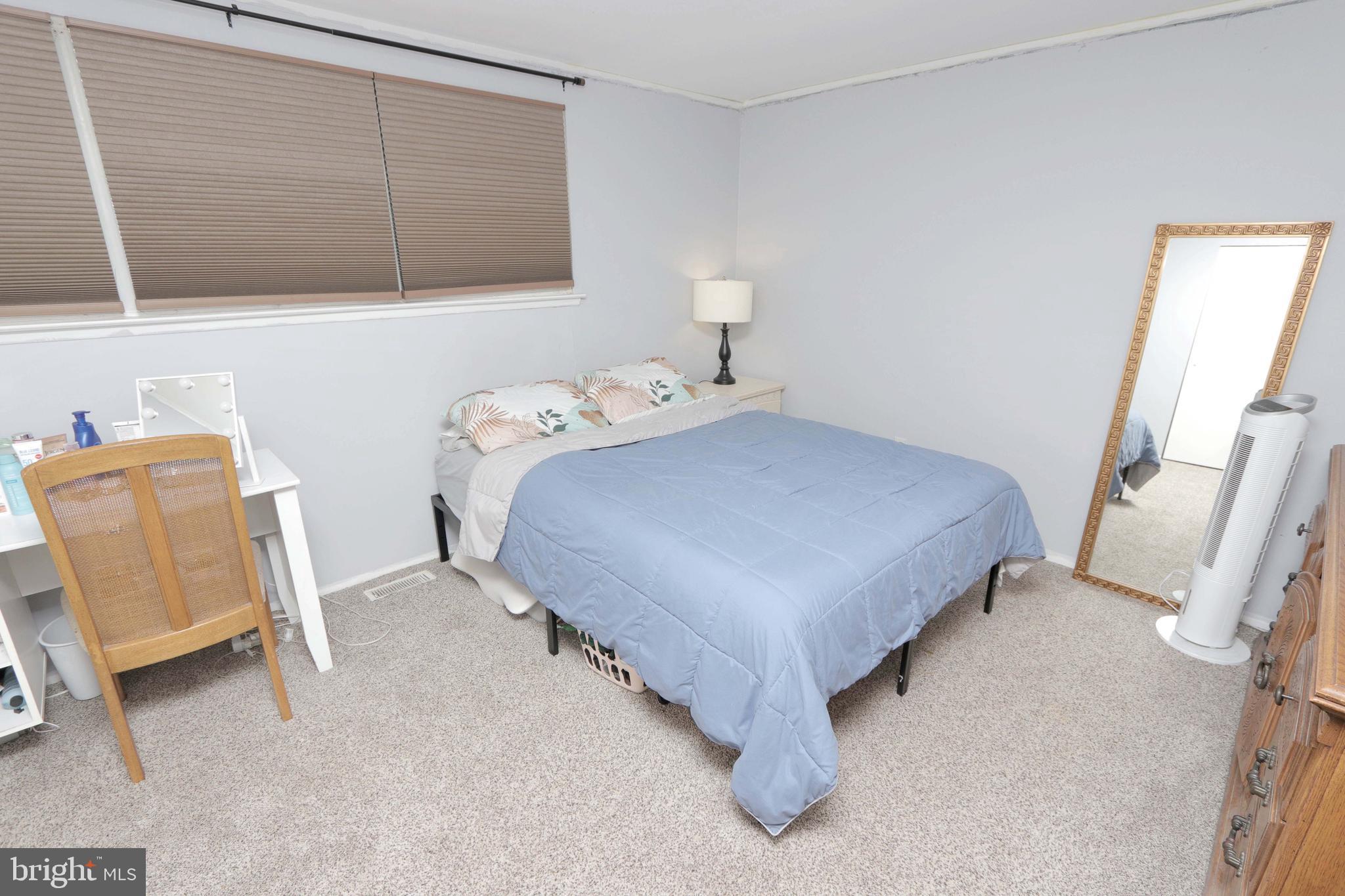 12124 Rambler Road Philadelphia, PA 19154 - Photo 15 of 26 a bedroom with a bed and a mirror