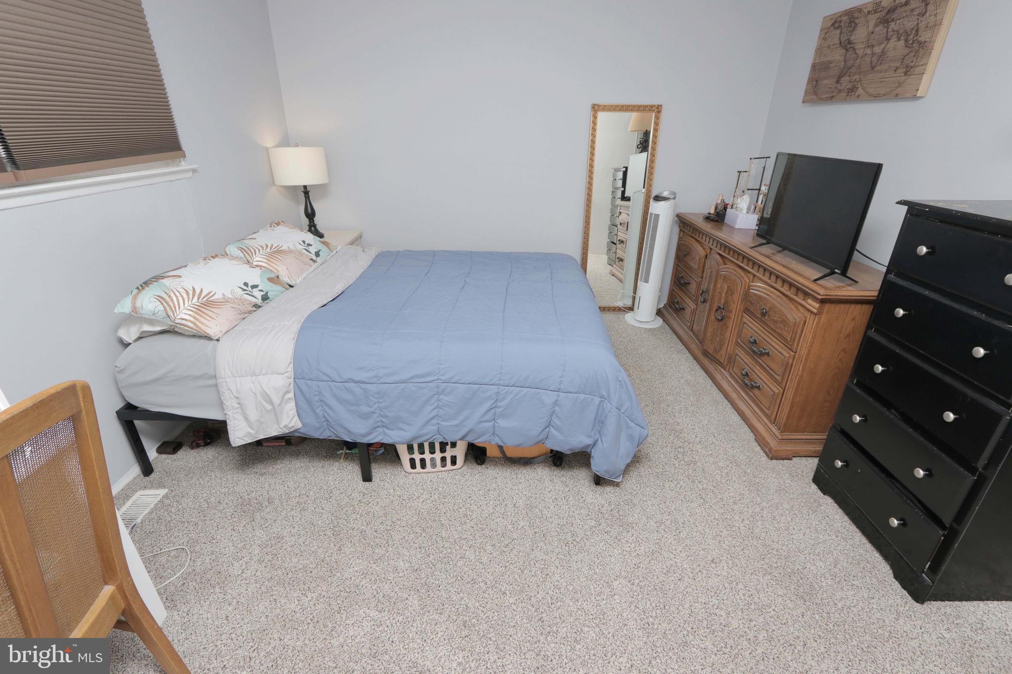 12124 Rambler Road Philadelphia, PA 19154 - Photo 16 of 26 a bedroom with a bed and wooden floor