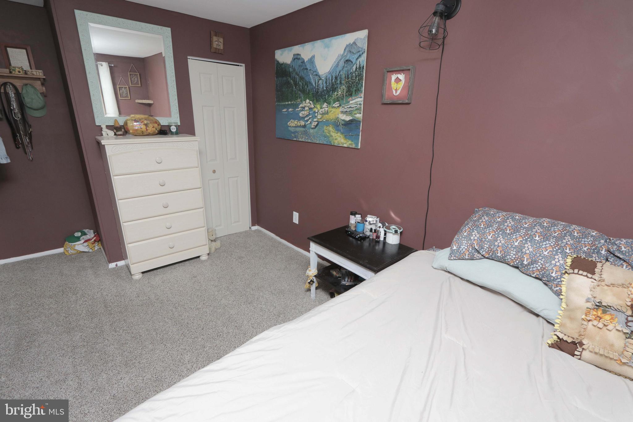 12124 Rambler Road Philadelphia, PA 19154 - Photo 21 of 26 a bedroom with a bed and a mirror