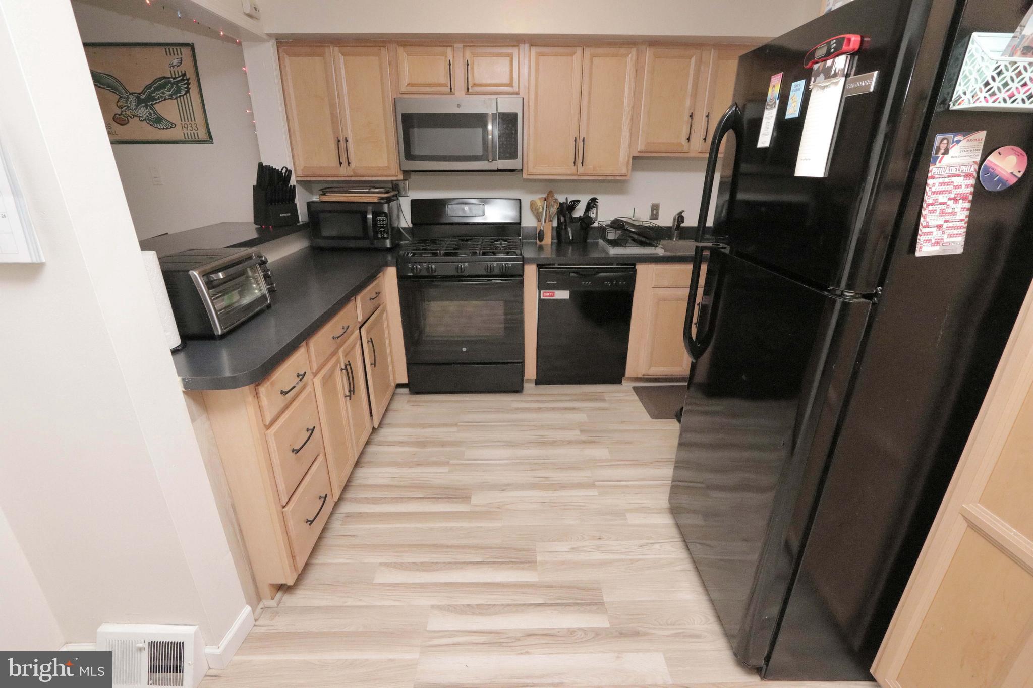 12124 Rambler Road Philadelphia, PA 19154 - Photo 8 of 26 a kitchen with granite countertop a refrigerator stove and sink