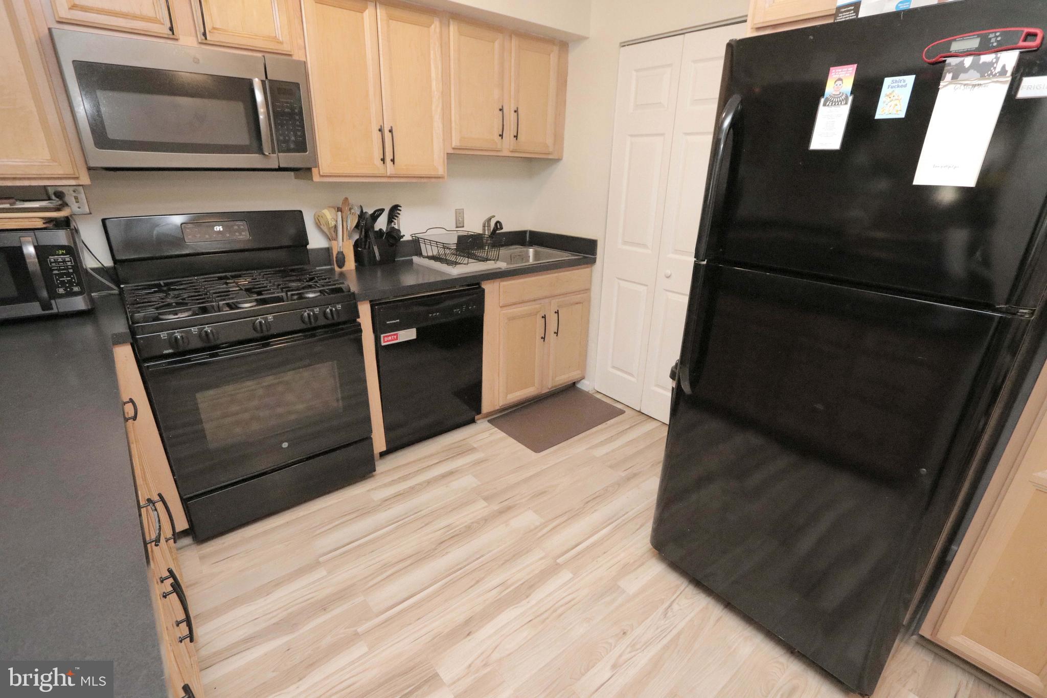 12124 Rambler Road Philadelphia, PA 19154 - Photo 9 of 26 a kitchen with a stove microwave and refrigerator