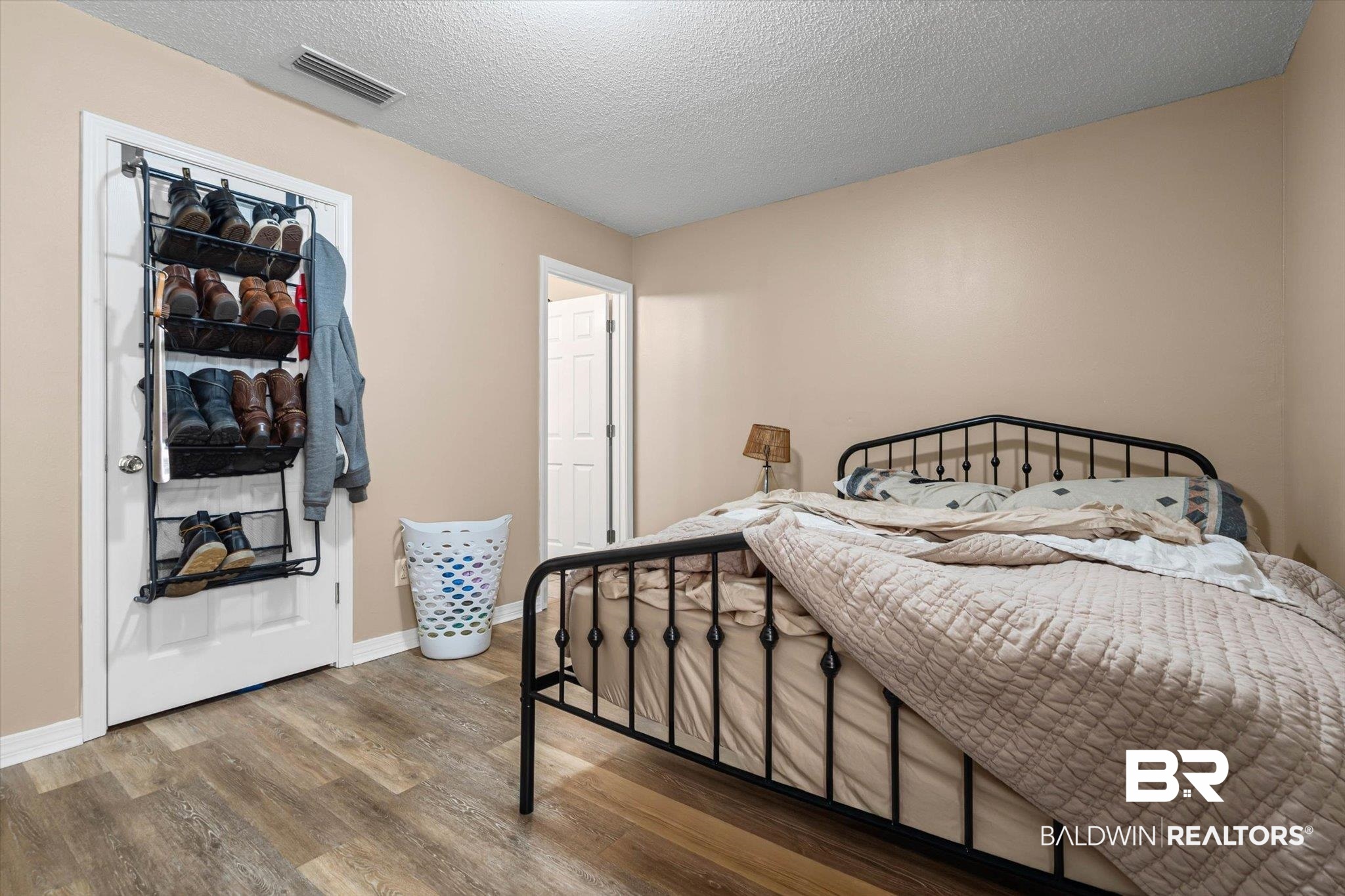 14165 River Oaks Road, Unit A & B Coden, AL 36523 - Photo 11 of 35 Bedroom featuring a textured ceiling and wood finished floors