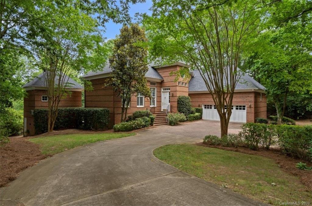 a front view of a house with a yard and tree s