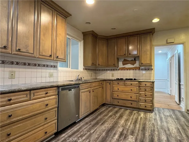 a kitchen with granite countertop stainless steel appliances and cabinets