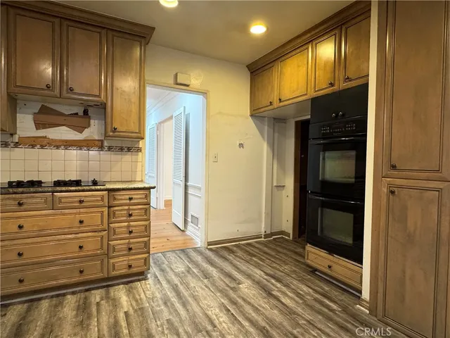 a view of walk in closet with wooden floor