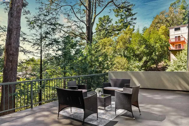 a view of a patio with table and chairs and potted plants