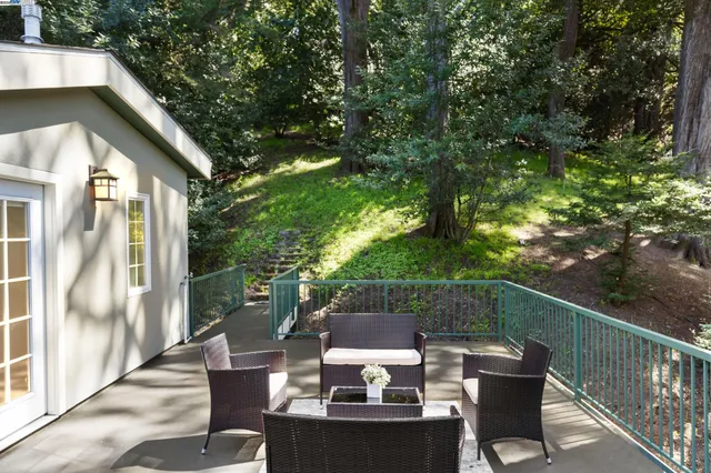a view of backyard of house with seating space