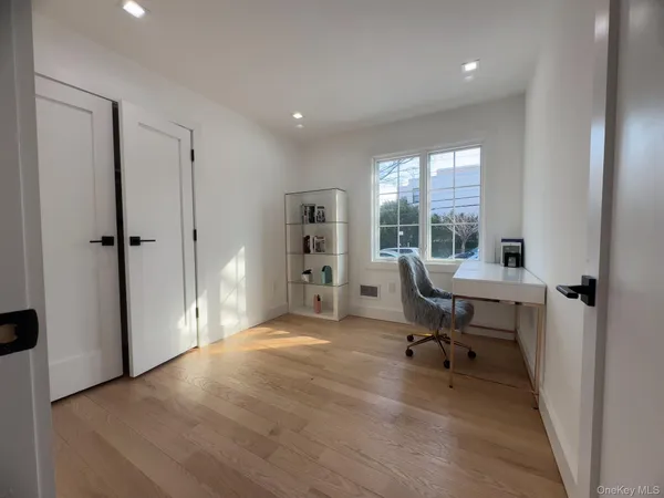 a view of a workspace with furniture and a window
