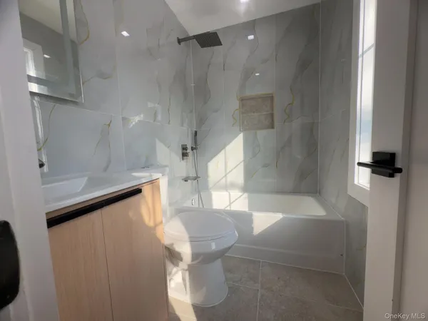 a bathroom with a bathtub and a shower