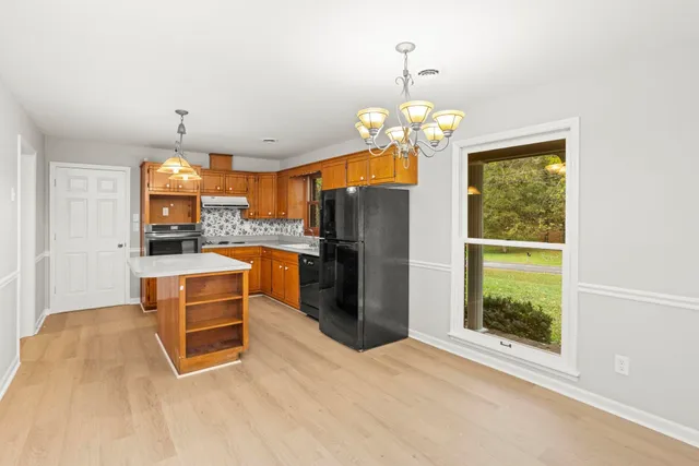 a view of dining room with furniture large window and refrigerator
