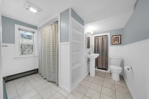 a bathroom with a sink toilet and shower