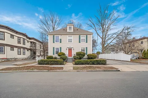 a front view of a house with a garden