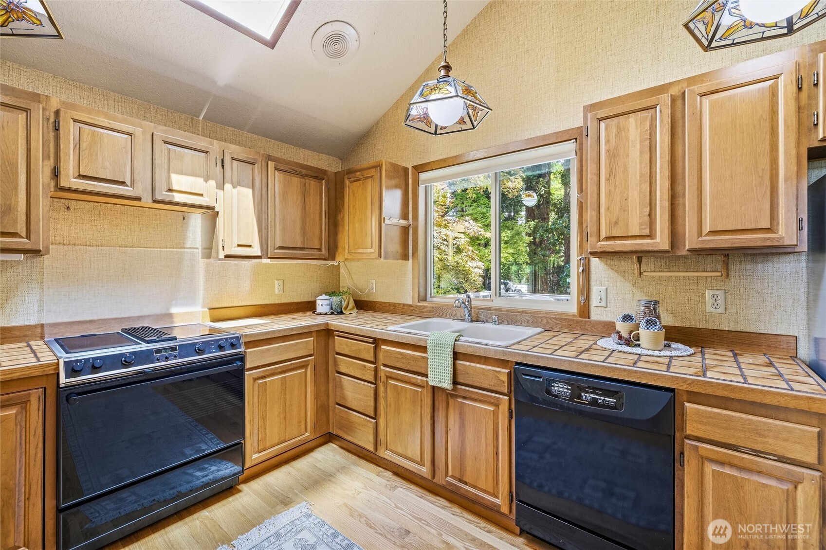 601 Clark Road Bellingham, WA 98225 - Photo 11 of 38 a kitchen with stainless steel appliances granite countertop a sink a stove a oven a refrigerator cabinets and a window