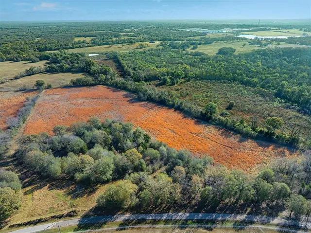 an aerial view of a houses with outdoor space and street view