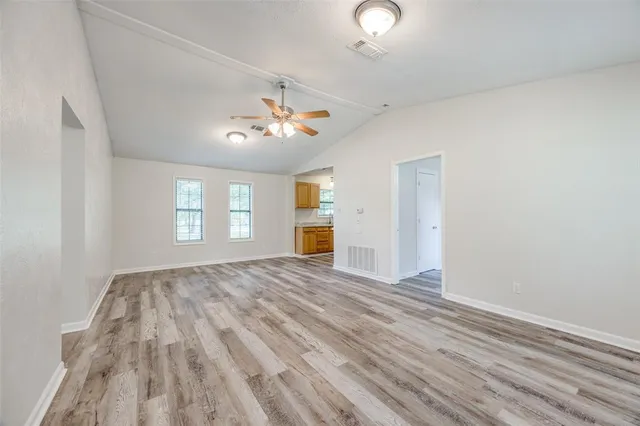 wooden floor in an empty room with a window