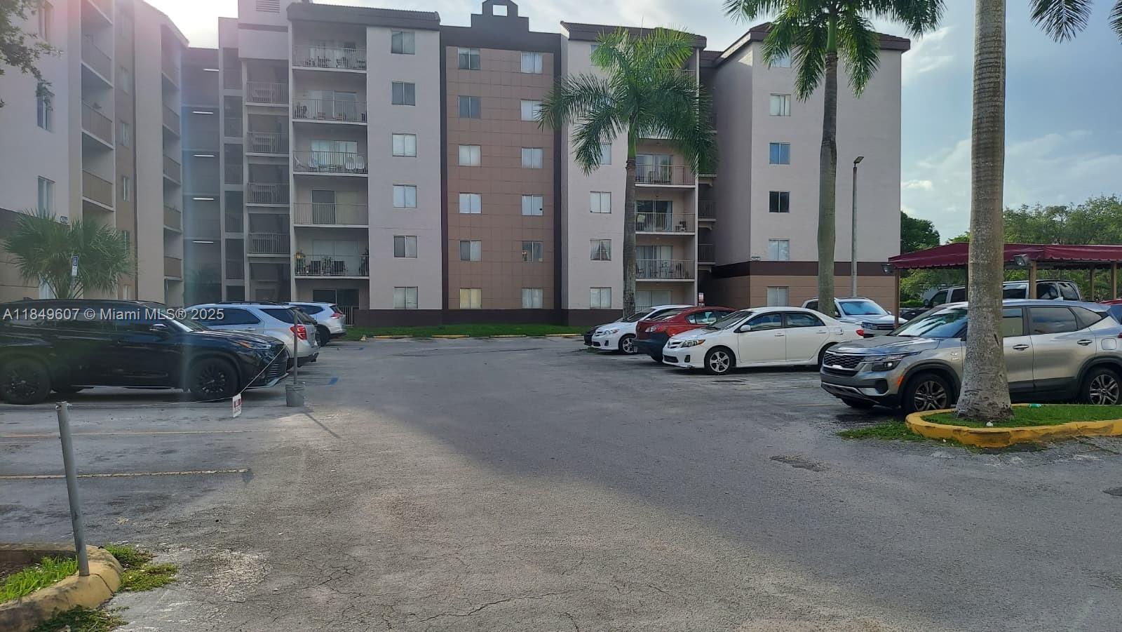 15231 Southwest 80th Street, Unit 209 Miami, FL 33193 - Photo 14 of 21 a cars parked in front of a building