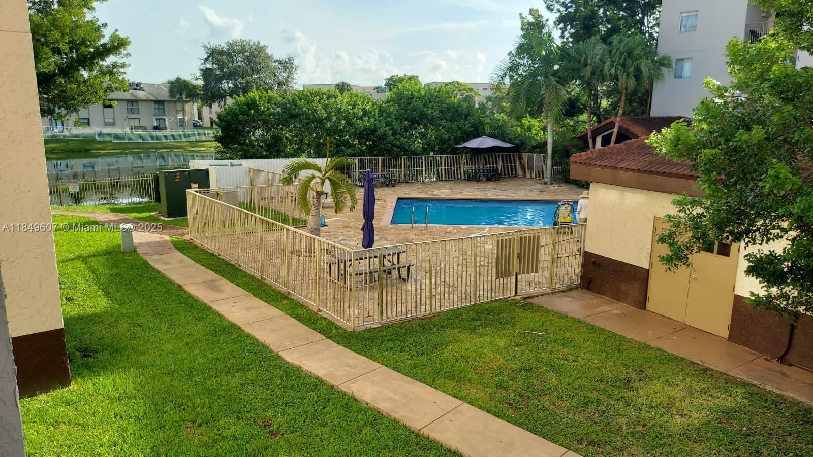 15231 Southwest 80th Street, Unit 209 Miami, FL 33193 - Photo 18 of 21 a view of a deck with a yard