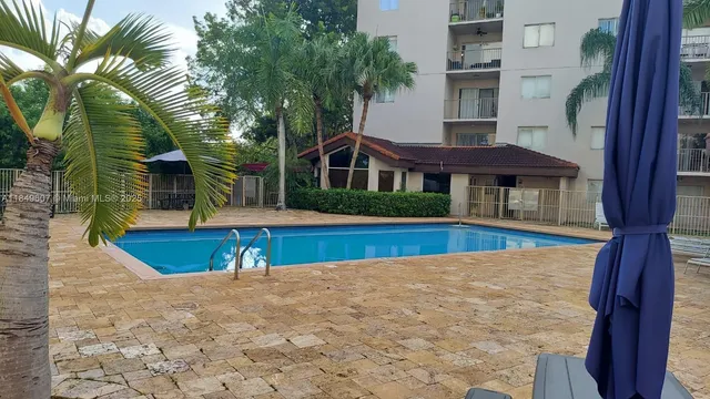 a view of house with a yard and potted plants