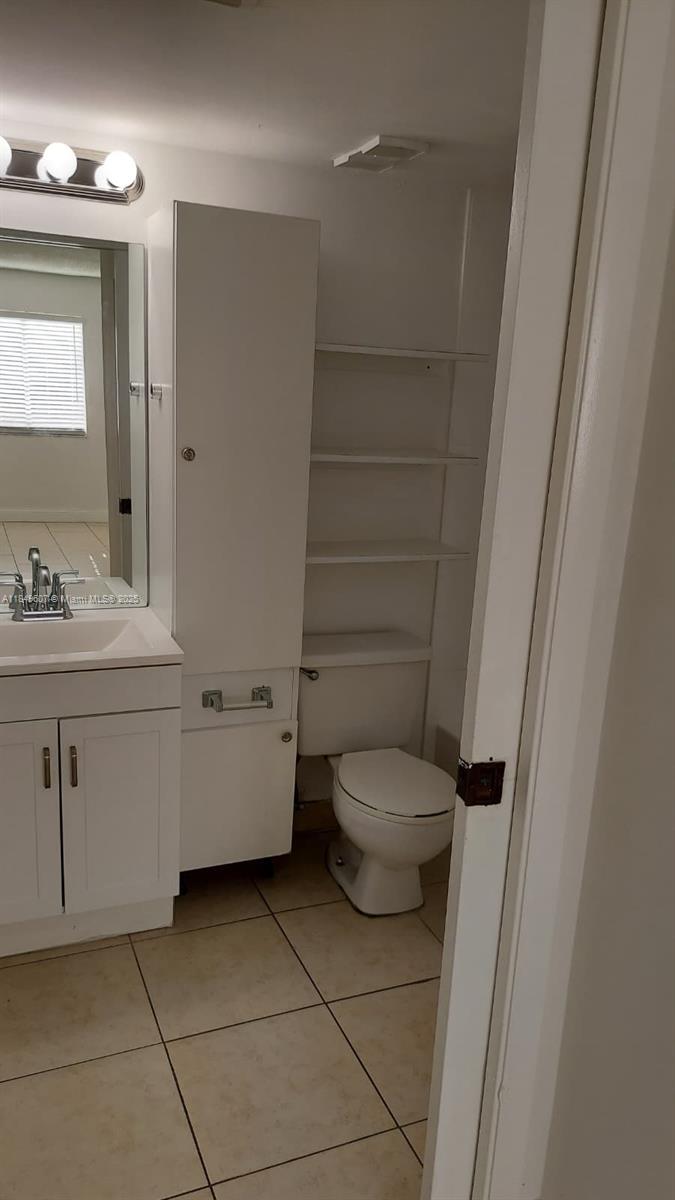 15231 Southwest 80th Street, Unit 209 Miami, FL 33193 - Photo 8 of 21 a bathroom with a sink a toilet and shower