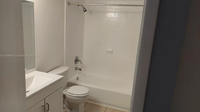 a white toilet sitting next to a bath tub
