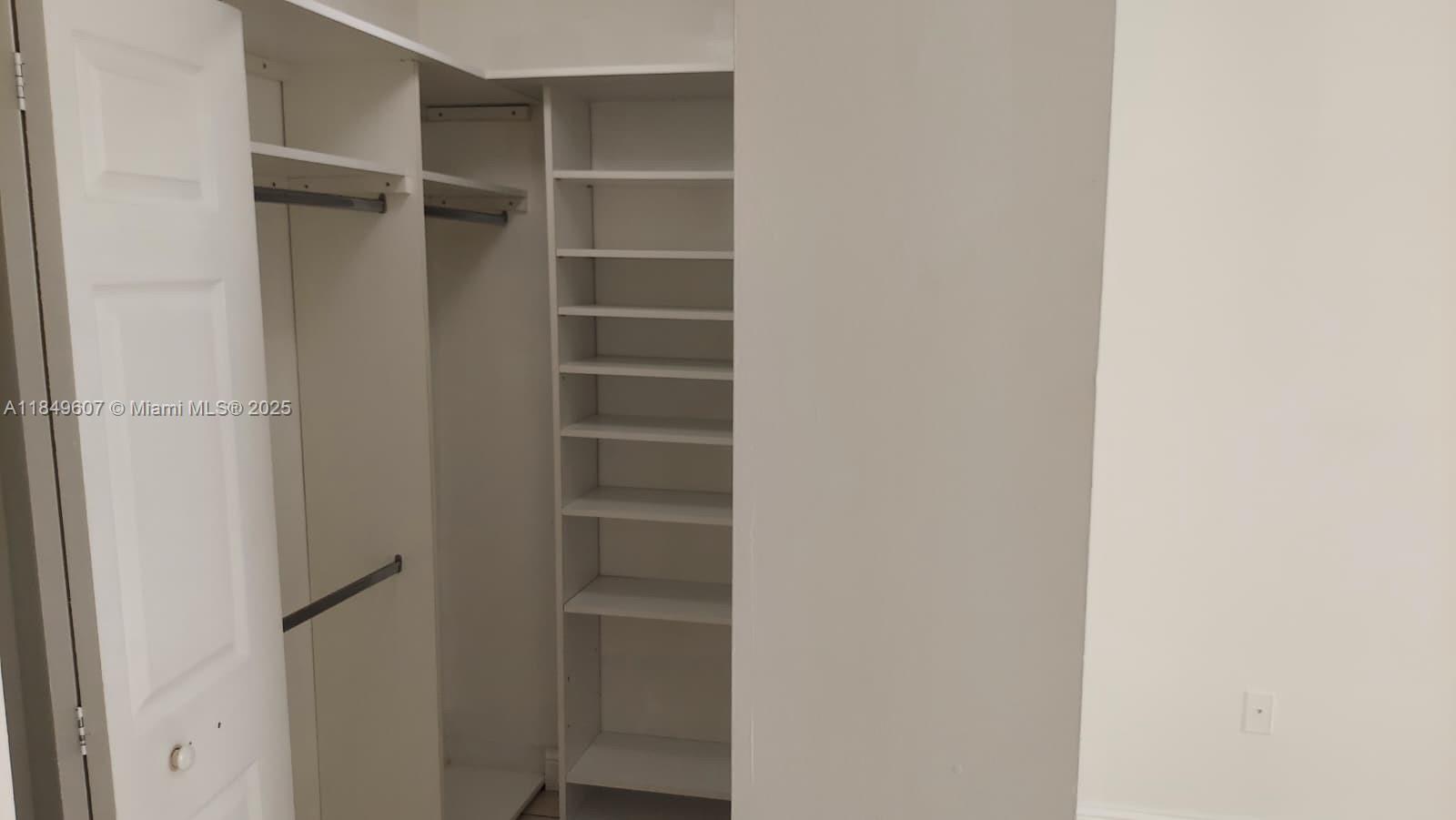 15231 Southwest 80th Street, Unit 209 Miami, FL 33193 - Photo 10 of 21 a view of walk in closet with empty racks