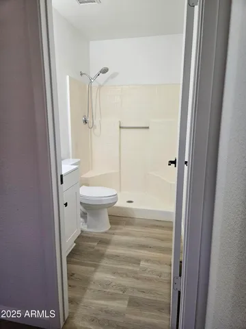 a bathroom with a toilet and a shower