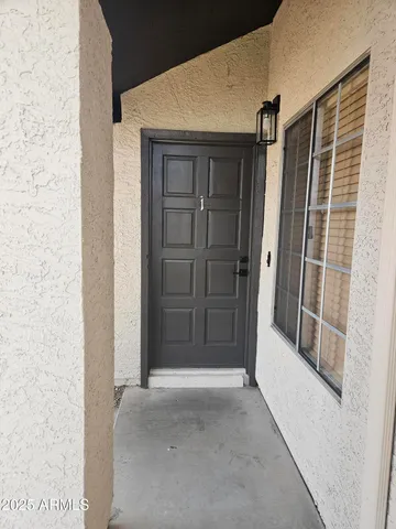 a view of empty room with wooden floor and ceiling fan