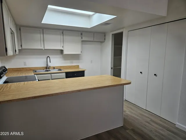 a kitchen with a sink cabinets and stainless steel appliances