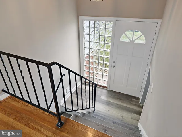 a view of staircase with wooden floor and a window