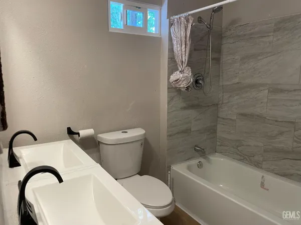 a bathroom with a toilet a sink and bathtub
