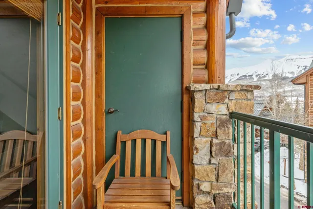 a view of a balcony with wooden floor and fence