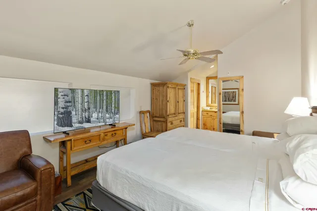 a bed room with a bed and a chandelier