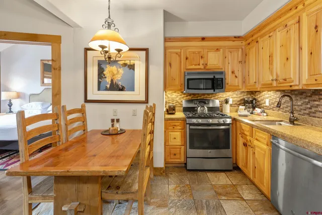 a kitchen with a stove a sink and a microwave