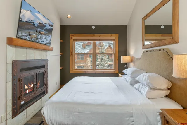 a bedroom with a bed and a fireplace