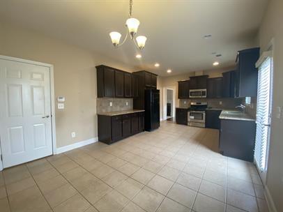 3829 Baxley Ridge Drive Suwanee, GA 30024 - Photo 5 of 11 a view of kitchen with stainless steel appliances granite countertop a refrigerator and a stove top oven