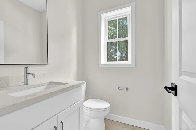 a bathroom with a toilet sink and window