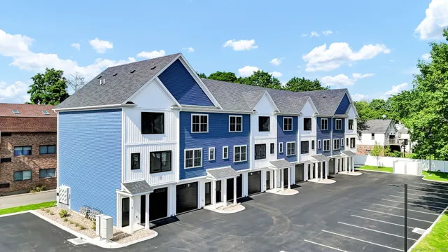 a view of a house with a yard and potted plants