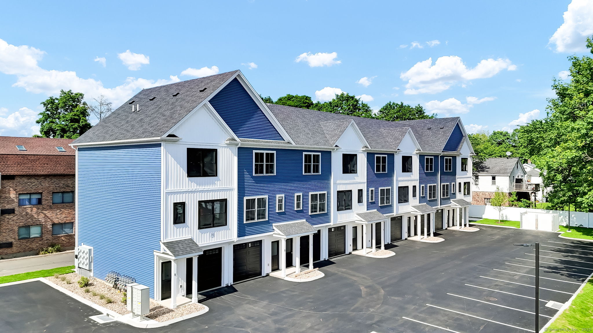 70 Whiting Street, Unit D Plainville, CT 06062 - Photo 2 of 26 a view of a house with a yard and potted plants