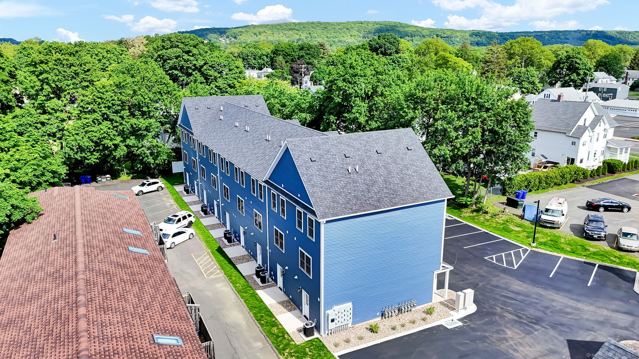 70 Whiting Street, Unit D Plainville, CT 06062 - Photo 23 of 26 an aerial view of a house with balcony and trees