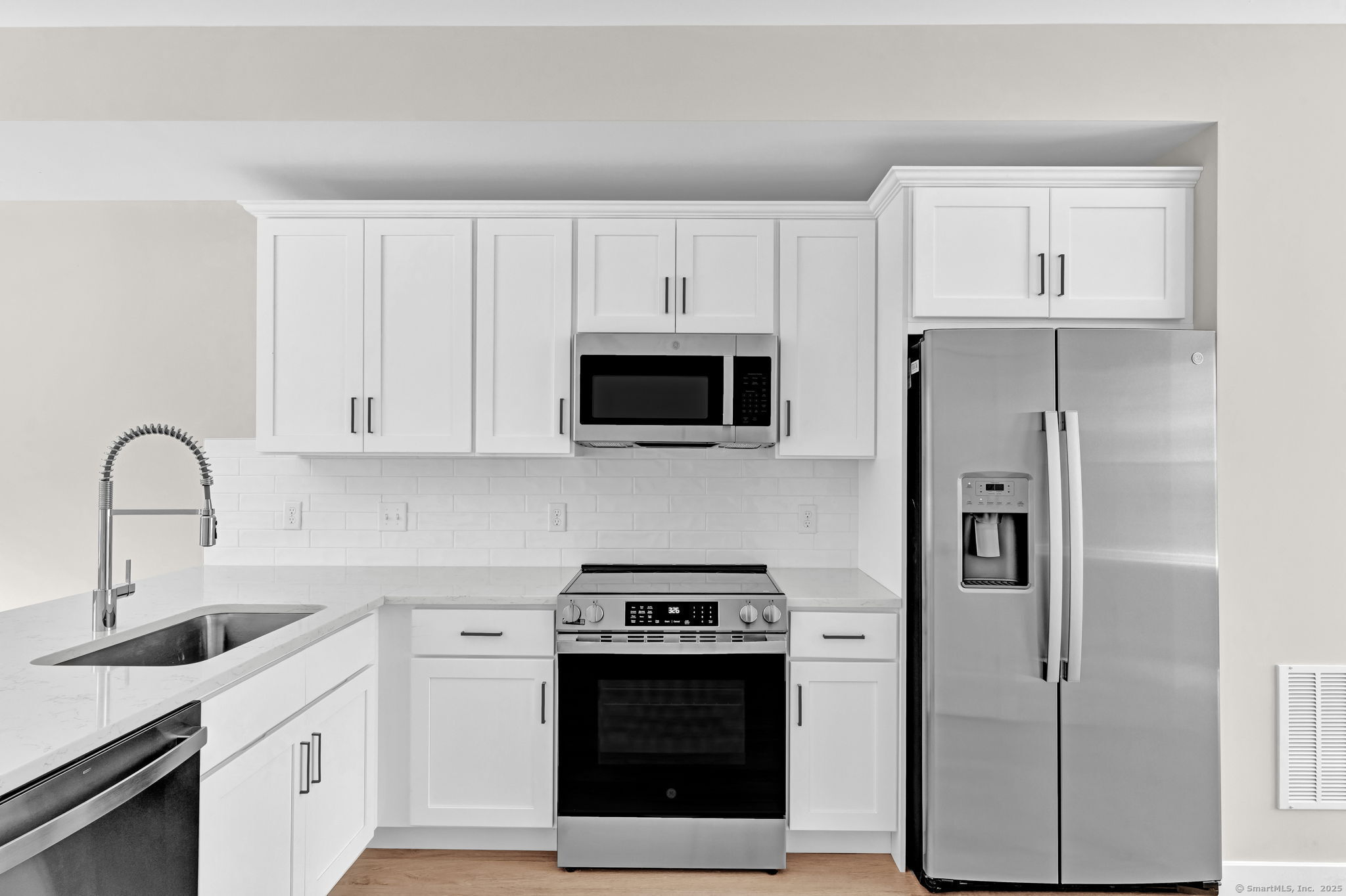 70 Whiting Street, Unit D Plainville, CT 06062 - Photo 4 of 26 a kitchen with stainless steel appliances a stove a microwave and a sink