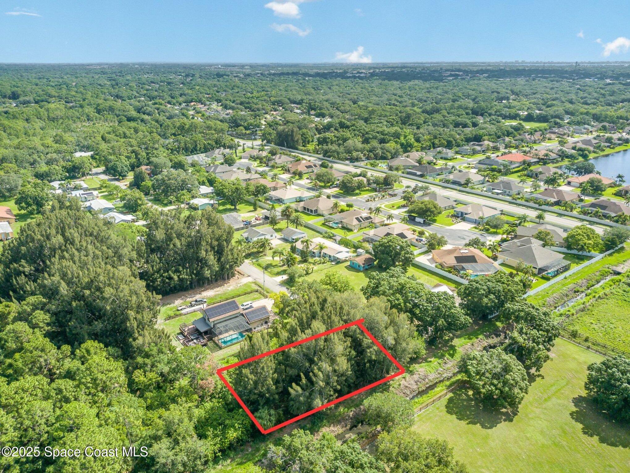 1545 Anson Road Melbourne, FL 32934 - Photo 17 of 19 an aerial view of residential houses with outdoor space and trees