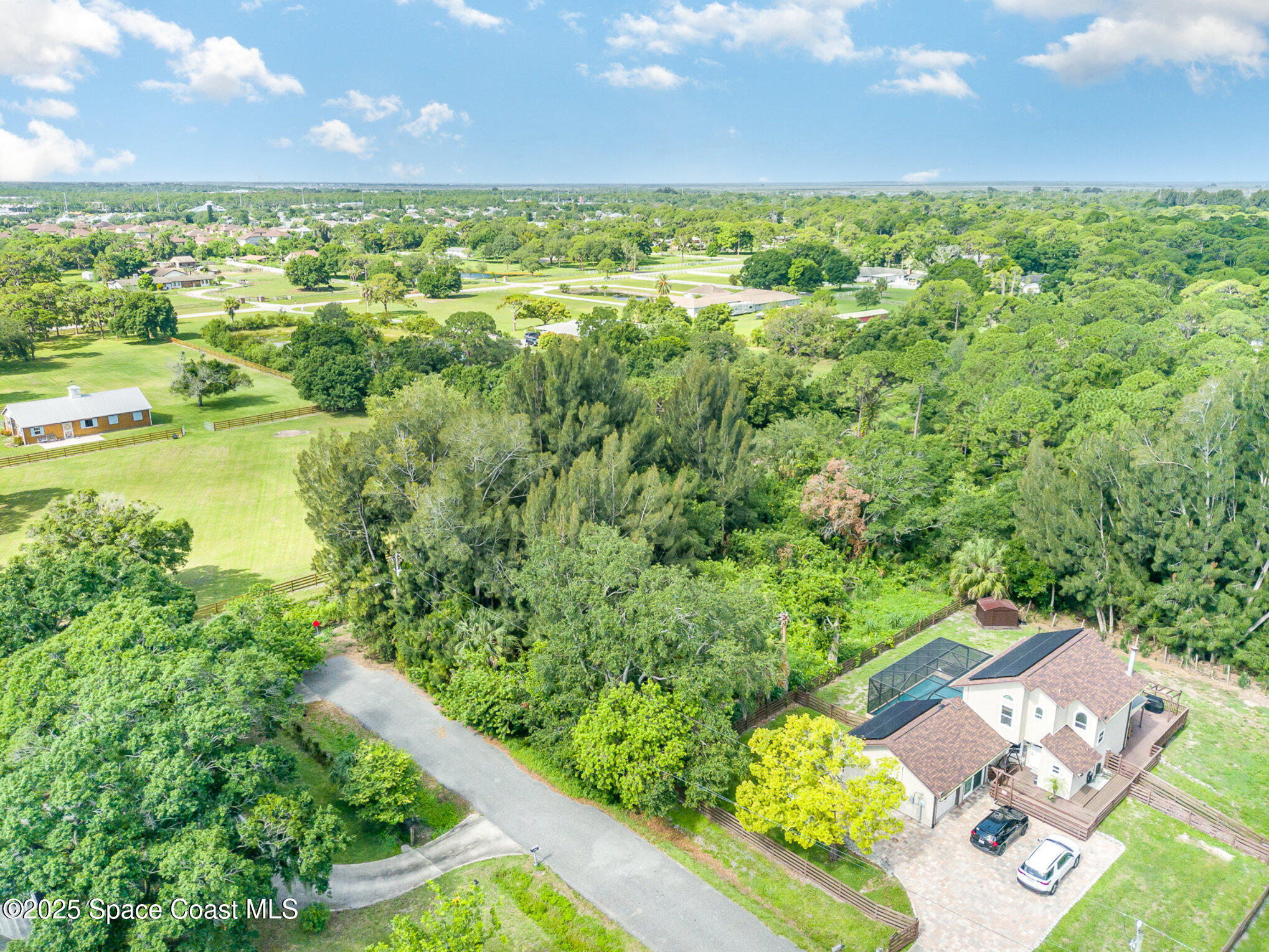 1545 Anson Road Melbourne, FL 32934 - Photo 6 of 19 a view of a city with lush green forest