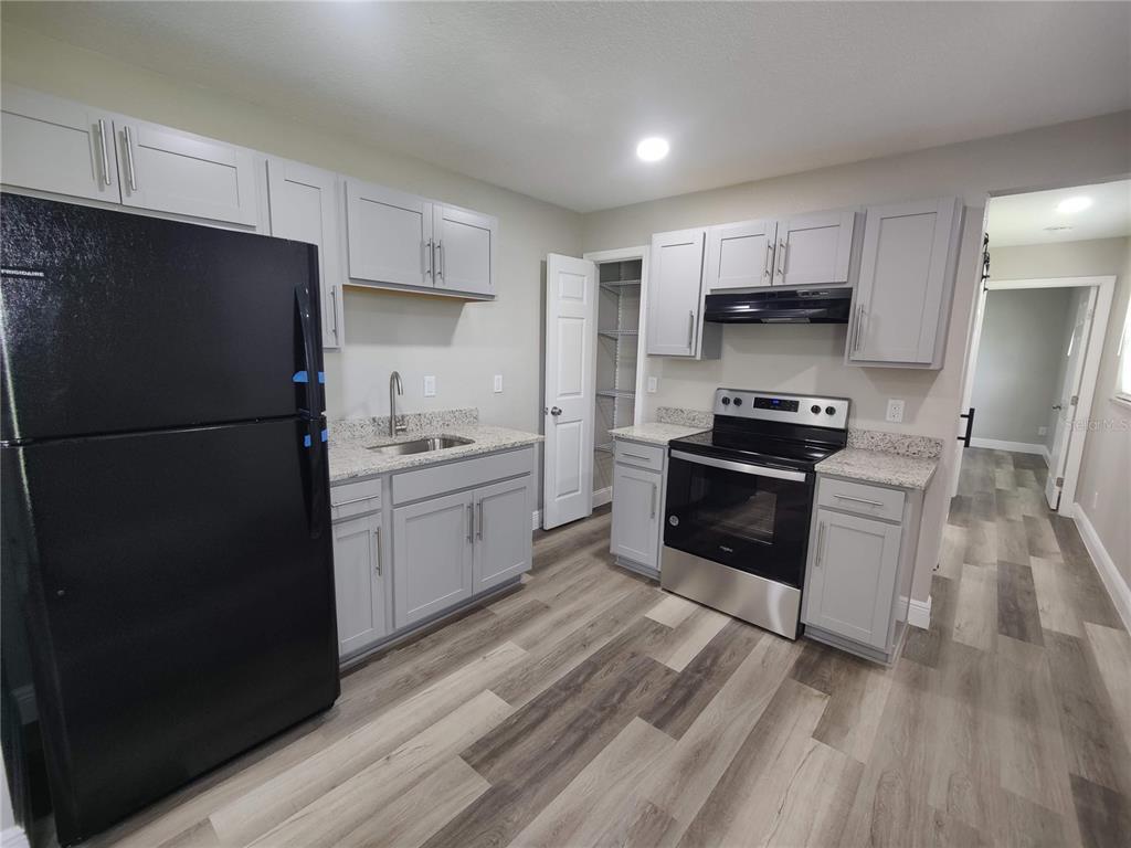 6804 Beth Road, Unit A Orlando, FL 32824 - Photo 3 of 14 a kitchen with stainless steel appliances a refrigerator stove and sink