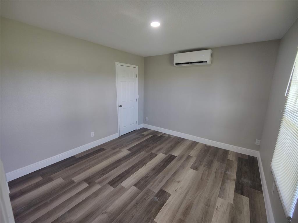 6804 Beth Road, Unit A Orlando, FL 32824 - Photo 10 of 14 a view of room with wooden floor