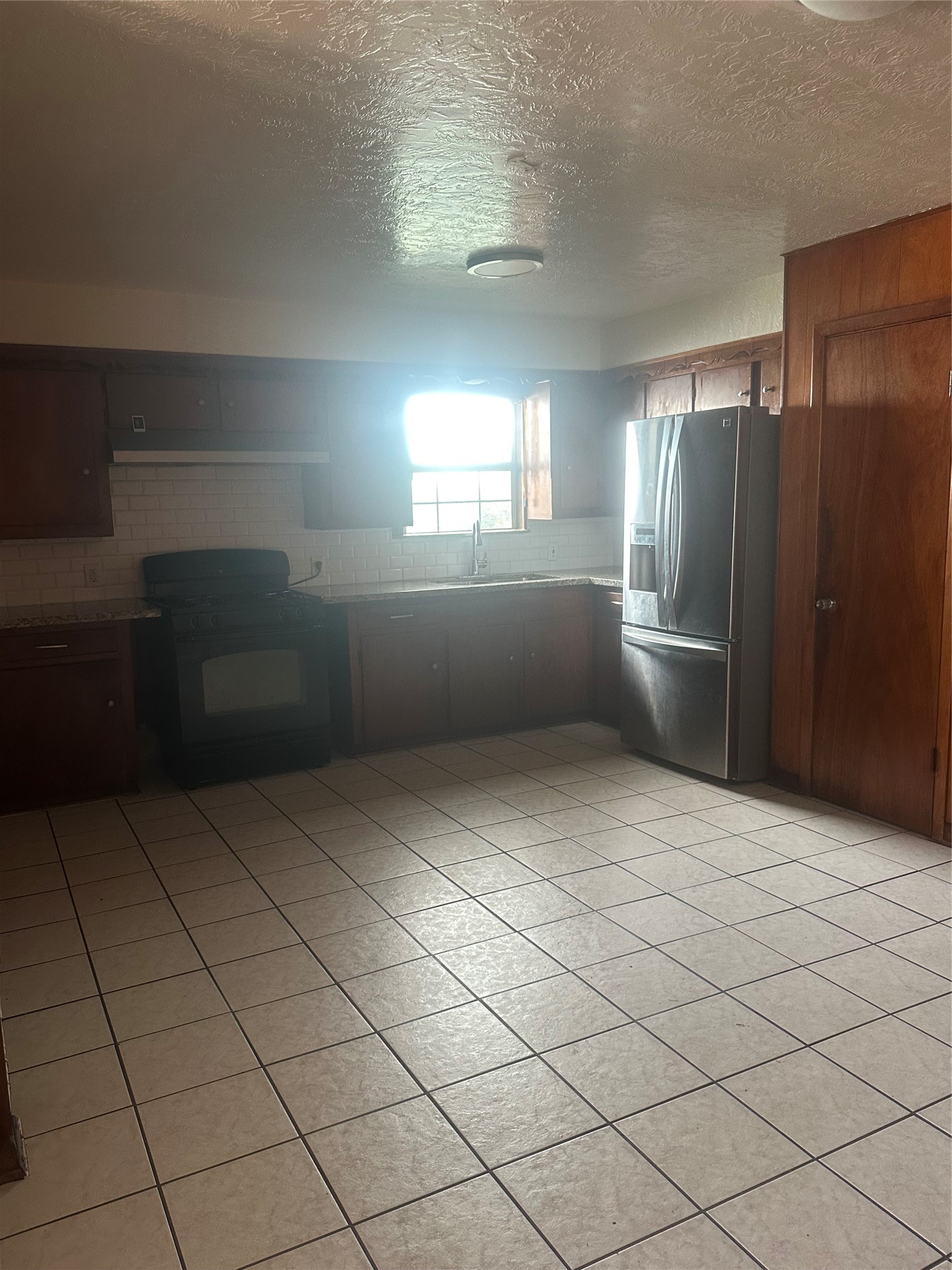 8214 Barkley Street Houston, TX 77017 - Photo 4 of 9 Spacious kitchen featuring ample cabinet space and tile floors.