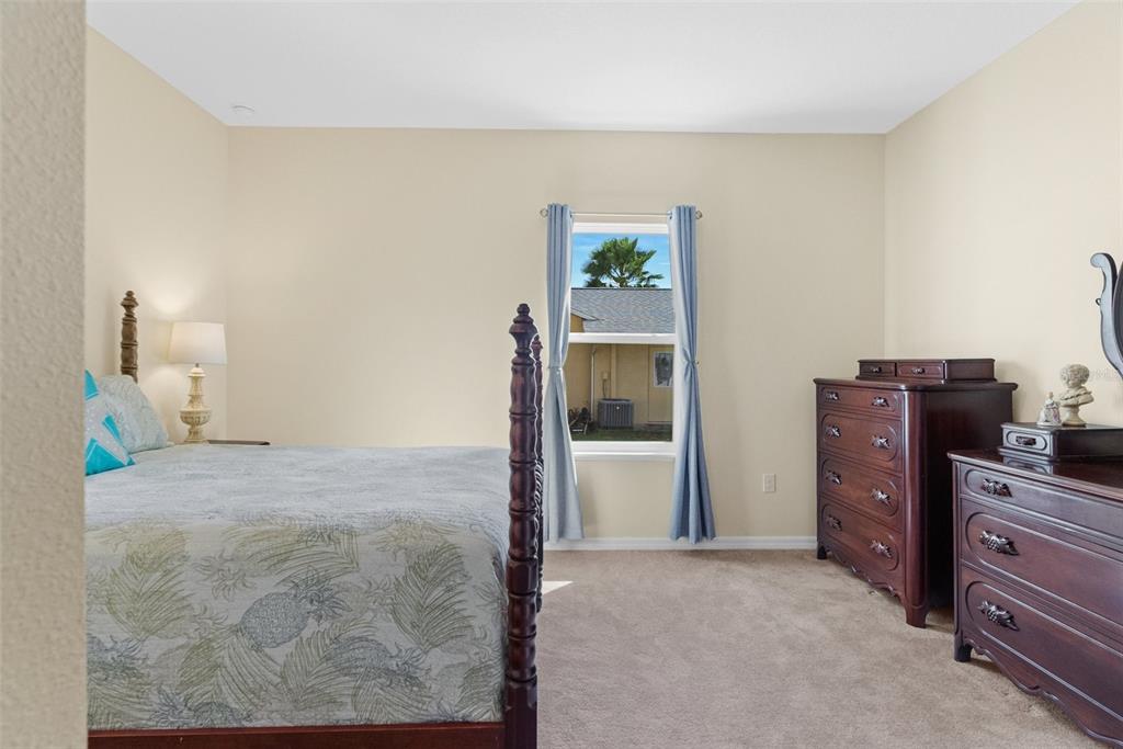 6283 Grapewood Road Spring Hill, FL 34609 - Photo 33 of 41 a view of a bedroom with furniture and closet
