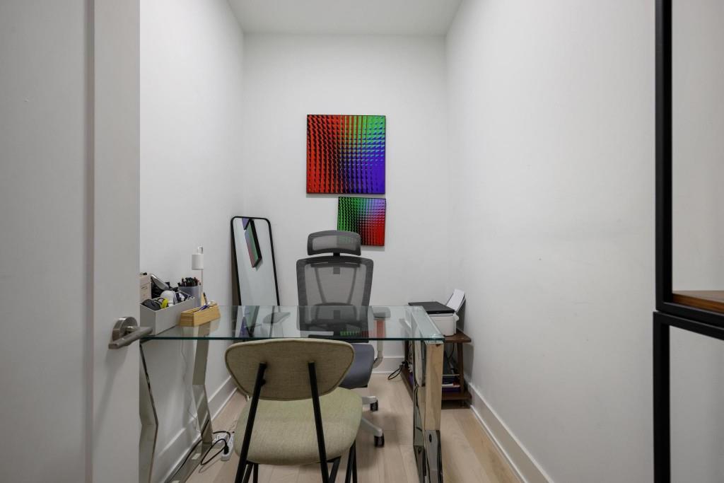775 Juniper Street Northeast, Unit 602 Atlanta, GA 30308 - Photo 23 of 40 a view of a workspace with furniture and wooden floor