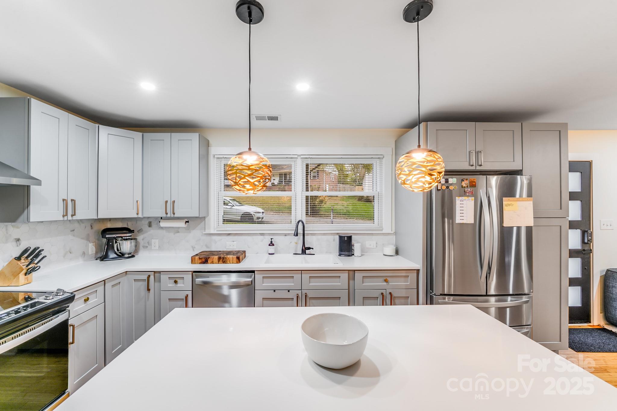 4910 Valley Stream Road Charlotte, NC 28209 - Photo 12 of 35 a kitchen with a refrigerator a sink and cabinets