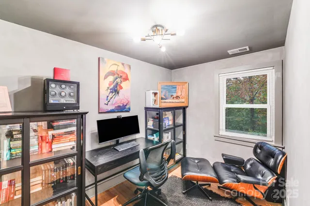 a living room with furniture a flat screen tv and a window